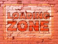 back alley loading zone painted red brick wall worn faded truck industrial sign Royalty Free Stock Photo