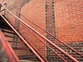 Back alley steps stairs rusting against a retro weathered aging brick warehouse building