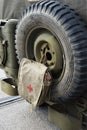 Back of antique military car with tyre and first aid kit attached