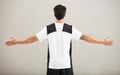 Back, athlete or model for fitness results, wellness and health isolated on grey background in studio. Arms out, man or