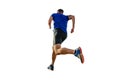back athlete runner in blue shirt and black tights running mountain