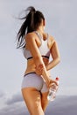 Back of athletic woman with bottle Royalty Free Stock Photo