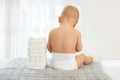 Back of a baby with a piles of diapers