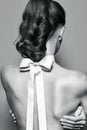Back of beautiful gentle girl with silk bow on the neck Royalty Free Stock Photo
