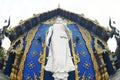 A large white Buddha image in the forbidding posture at The back of the beauty blue chapel of Wat Rong Suea Ten temple