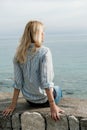 Back of blonde woman traveler enjoying the views on sea in summer. Montenegro