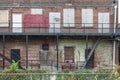 Back of a boarded up abandoned red brick apartment building