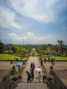 The back of Borobudur Temple with stairs and a backdrop of mountain views and clear sky