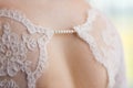 Back of bride in wedding dress with string of pearls Royalty Free Stock Photo