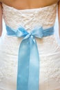 Back of bride in white lace wedding dress with blue ribbon Royalty Free Stock Photo