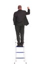 Back of business man writing on a ladder Royalty Free Stock Photo