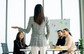 Back of business woman with long hair present about the project in front of her coworkers and they look happy to enjoy for the Royalty Free Stock Photo