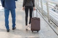 Back of businessman and businesswoman walk together with luggage on the public street Royalty Free Stock Photo