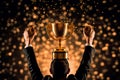 Back of a businessman raising fists and putting trophy on his head, celebrating after winning with golden confetti, succees Royalty Free Stock Photo