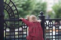 Back of caucasian child of two years climbing up on the fence Royalty Free Stock Photo