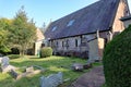 The back of a church in a Devon village. The graveyard is in a state of disrepair