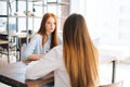 Back close-up view of unrecognizable woman applicant being interviewed by serious female HR managers reading resume Royalty Free Stock Photo