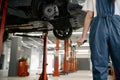 Back cropped view on female mechanic hand holding spanner wrench tool Royalty Free Stock Photo