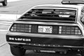 Back of a DMC DeLorean car shot in black and white parked outside