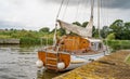 Traditional wooden sailing boat moored up on the River Bure, Norfolk Broads, UK