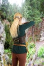 Back of female elf shooting a bow and arrow Royalty Free Stock Photo
