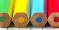 The back of four colored pencils on a notebook sheet of paper. Macro photography with a small focus depth. Royalty Free Stock Photo