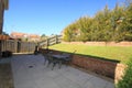 Back garden with paved area and sloping lawn