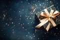 Back gift box with golden ribbon bow and confetti on dark background with lights and sparkles Royalty Free Stock Photo