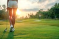 back of golfer woman with sexy legs in shorts playing golf with golf club on lawn on golf course in summer on sunny day Royalty Free Stock Photo