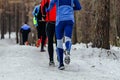 back group runners athletes running winter trail marathon