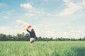 Back of happy young woman standing on green field enjoy with fresh air. Royalty Free Stock Photo