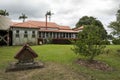 Back of an historical heritage listed homestead with a small old dog house in the garden under a cloudy sky Royalty Free Stock Photo