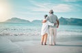 Back, hug or old couple on beach to relax with love, care or support on summer vacation in nature. Retirement, mature Royalty Free Stock Photo