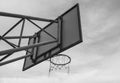 The back image of the basketball board hoop with the loop on the sky background. Black and white style tone