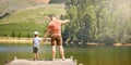 Back, lake and a father holding hands with his son while looking at the view while outdoor in nature together. Love Royalty Free Stock Photo