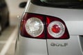 Back lamp of a parked silver colored Volkswagen Golf Plus in a parking