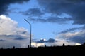 Back light Lamp post meadow and Dark blue stormy cloudy sky in evening