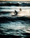 Back light view of a couple of surfers waiting for the wave Royalty Free Stock Photo