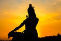 Back lit statue of hindu god lord shiva in meditation posture with dramatic sky from unique angle Royalty Free Stock Photo