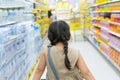 Back of little Asian Girl in Super Store. Royalty Free Stock Photo
