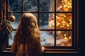 The back of little girl looking out of window at Christmas tree in snowing night, generative AI