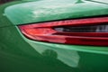 Back of a luxury green sports car. Backlight closeup. Royalty Free Stock Photo