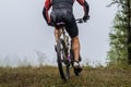 back male mountain bike cyclist riding on forest trail Royalty Free Stock Photo