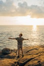 Back of man with raised hands on the sunset near the sea Royalty Free Stock Photo