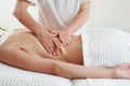 Back massage. Masseur massaging young woman on massage table in spa salon. Young woman relaxing during back massage at Royalty Free Stock Photo