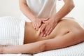 Back massage. Masseur massaging young woman on massage table in spa salon. Young woman relaxing during back massage at Royalty Free Stock Photo