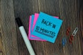 Back in 10 Minutes on sticky notes isolated on Office Desk Royalty Free Stock Photo
