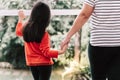 The back of the mother, and the 6 year old daughter standing and holding hands Royalty Free Stock Photo