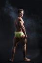 Back of muscular young bodybuilder in relaxed pose Royalty Free Stock Photo