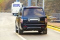 Back of new black SUV car parking on the asphalt road Royalty Free Stock Photo